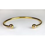 A 9ct gold torque bangle.