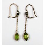 A pair of vintage yellow metal (tested gold) peridot and diamond drop earrings.