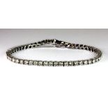 An 18ct white gold diamond set line bracelet. Est. £1,500 - £2,000