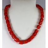 A single row necklace of large coral beads.