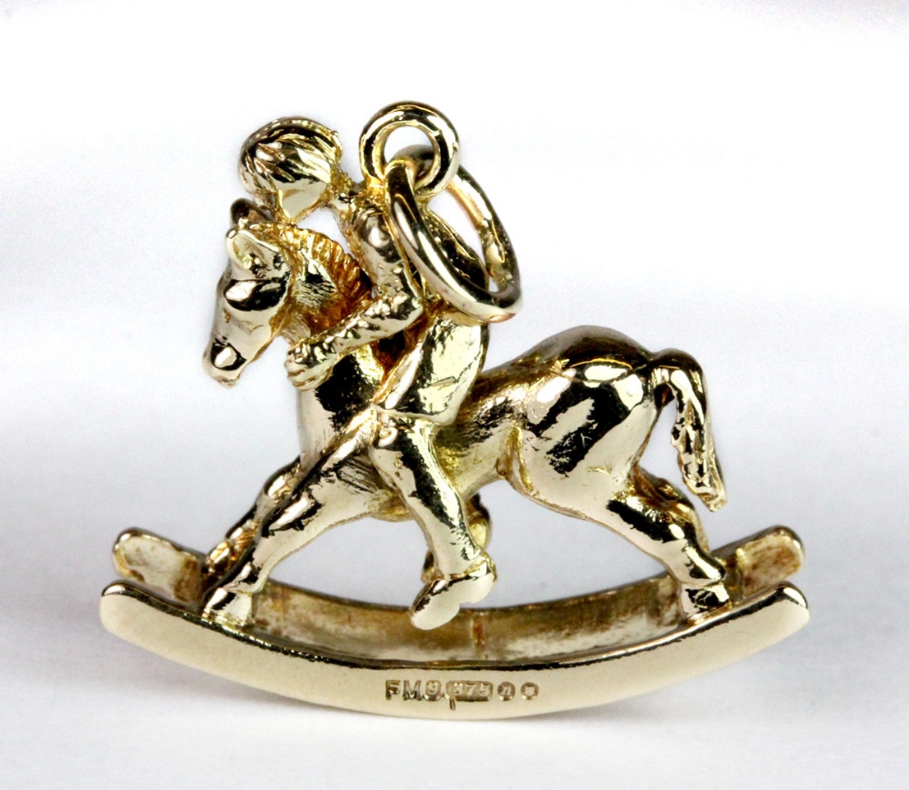 A 9ct gold heavy articulated rocking horse and rider pendant/charm, W. 2.2cm.