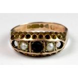 An antique 9ct gold garnet and seed pearl ring (2 stones missing) (M).
