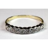 A 9ct gold cubic zirconia half eternity ring (Q).