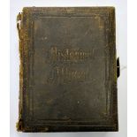 Two 19th century leather bound photograph albums, one containing a music box movement.