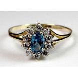 A 9ct gold cubic zirconia and blue topaz cluster ring (Q.5).