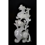 A very finely carved 19th/early 20thC Chinese white jade figure of a phoenix sitting on a dragons