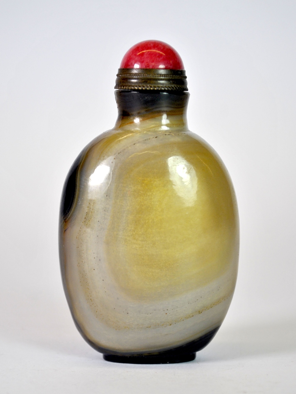 An unusual Chinese banded agate snuff bottle (well hollowed) with gilt and pink hardstone stopper,