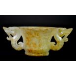 A Chinese archaic form carved jade cup with dragon handles, W. 13cm.