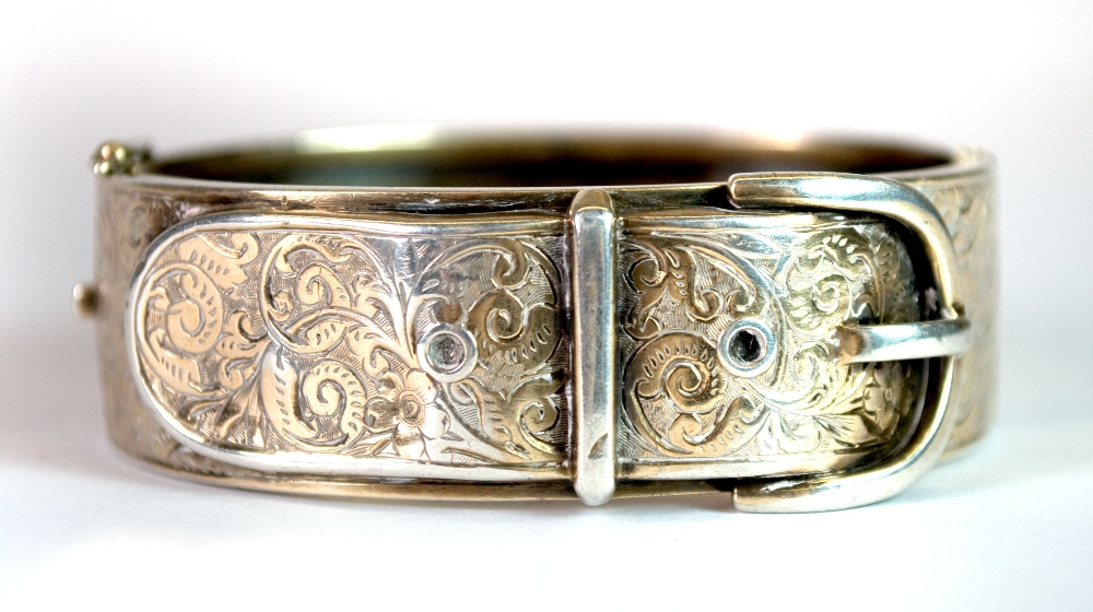 A white metal (tested silver) gilt buckle bangle.