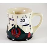 A Moorcroft 'Mackintosh' pattern mug signed by Emma Bossons and dated 21/09/2003, H. 8.5cm, (Boxed),