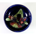 A Moorcroft pottery 'Orchids' design small footed bowl, Dia. 11cm H. 4cm. Excellent condition.