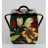 A Moorcroft biscuit barrel decorated in the 'Pencarrow' pattern, designed and signed by Emma