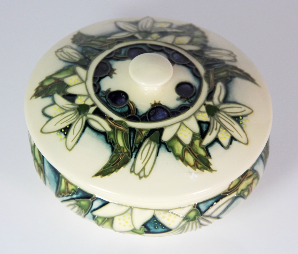 A Moorcroft 'Juneberry' pattern circular box and lid, c. 2000, Dia. 13cm, H. 8cm. Excellent