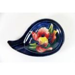 An early Moorcroft 'Orchid' design ashtray with the original Moorcroft label to base, W. 15cm x D.