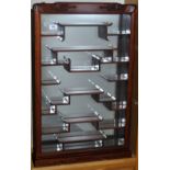 A Chinese style wall mounted hardwood cabinet suitable for a collection of snuff bottles, jades,