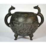 An early 20th century Chinese cast and incised bronze censor with dragon handles, H. 19cm.