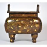 A Chinese cast bronze censor with gold leaf highlights, H. 15cm. Est. £200 - 300