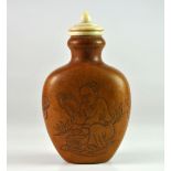 An unusual Chinese snuff bottle made of a natural gourd grown into a decorative mould with an