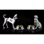 An interesting pair of silver plated dog salts, H. 8cm.