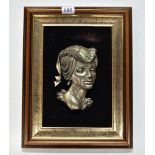 A framed relief plaque of a young woman, 33 x 43cm.