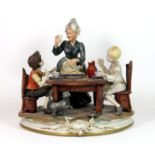 A signed Capodimonte group figure, H. 27cm.