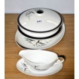 A Royal Doulton china dinner serving set consisting of two tureens, meat plate and a sauce boat.