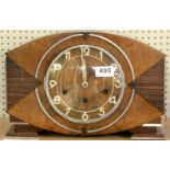 An Art Deco mixed wood mantle clock, W. 54cm.