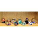 Nine glass paperweights including Caithness.