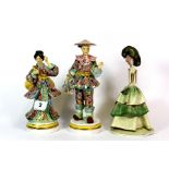 A pair of Italian hand painted porcelain 1950's figures and a 1960's figure, H. 20cm.