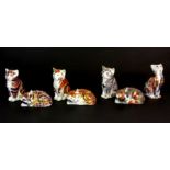 Seven Crown Derby cat paperweights.