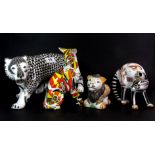 Four decorative porcelain cat figures.