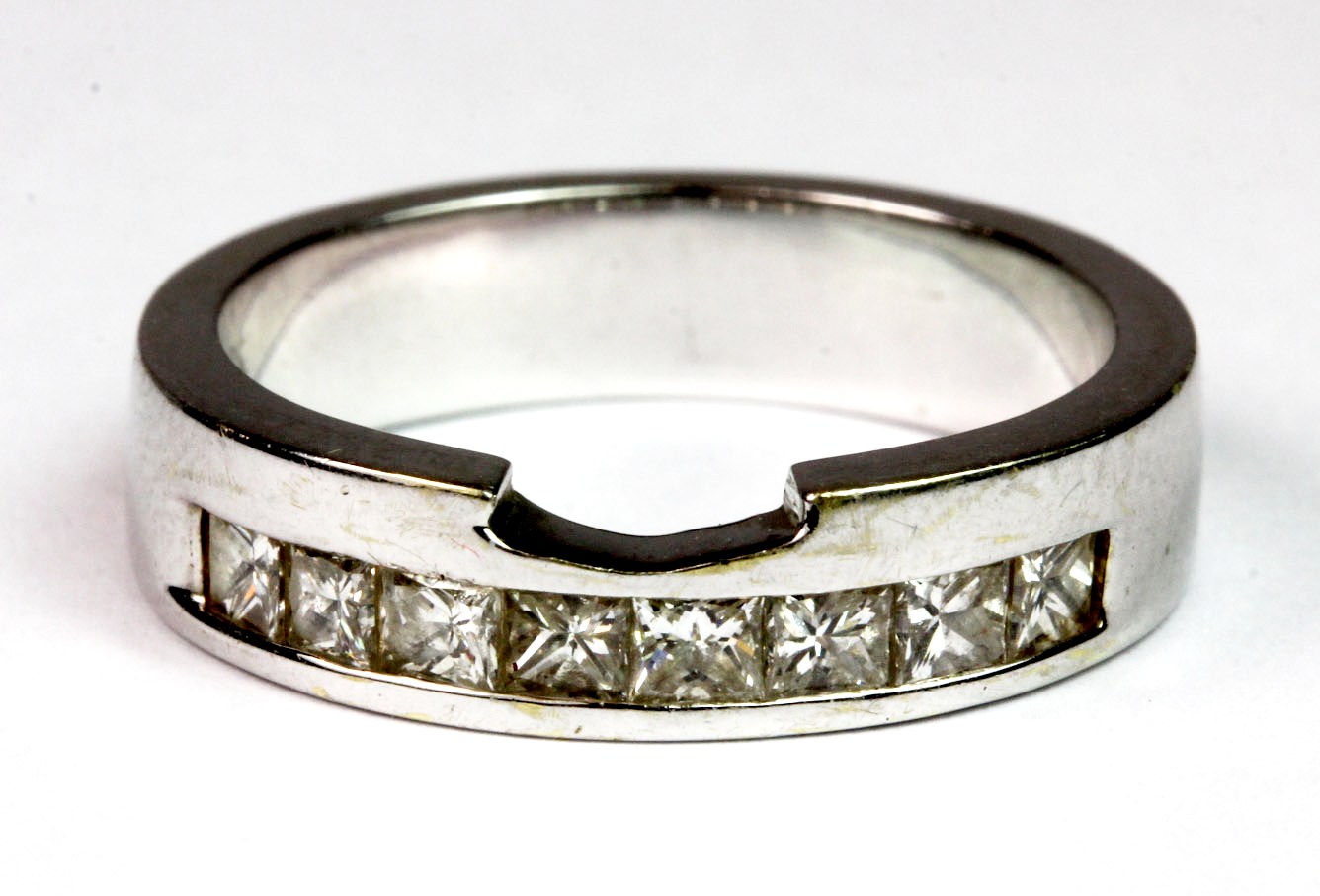 A 14ct white gold (stamped 585) ring set with princess cut diamonds. (P.5), approx. 6.7g. Please