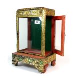 An early 20th century Siamese gilt and mirror decorated Deity cabinet, H. 40cm, W. 26cm.