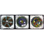 Three large boxed glass paperweights, Dia. 10cm.