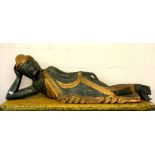 A large Thai painted and gilt carved wooden figure of a reclining Buddha, L. 152cm.