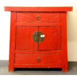 A Chinese red painted brushed elm cabinet, H. 68cm, W. 68cm.