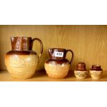 Two 19thC Doulton harvest jugs and a pair of Doulton Lambeth Haig and Haig advertising salt and