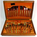 A cased 1970's gold plated cutlery set.