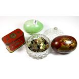 A glass powder bowl and contents, with a Japanese lacquered egg, a celluloid egg and a coronation