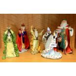 Four Enchantica resin figurines and a porcelain figure of Father Christmas.