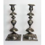 A pair of white metal candlesticks, bearing the makers mark for M. Lassman, of baluster form,