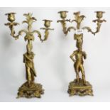 A 19th century French pair of ormolu twin branch figural candlesticks, the columns each in the