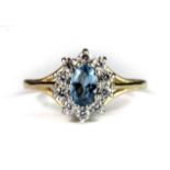 A 9ct yellow gold blue topaz and cubic zirconia cluster ring (P).