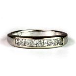 A 9ct white gold stone set half eternity ring (M.5).