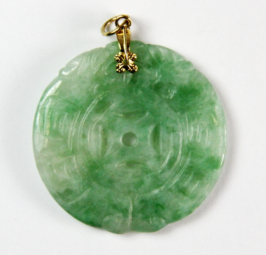 A Chinese carved lucky cash jadeite pendant, Dia. 3.5. Private estate purchased c. 1973.