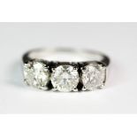 An impressive 18ct white gold (stamped 750) ring set with three brilliant cut diamonds (3ct diamonds