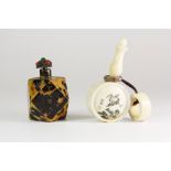 An interesting Chinese engraved camel bone snuff bottle with ring carrying handle, L. 8cm,