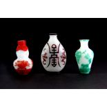 Three mid 20th century Chinese carved Peking glass snuff bottles. The late Bob Marion collection.