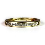 A pretty 14ct yellow gold half eternity ring set with baguette cut white stones (O.5).