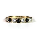 A 9ct yellow gold sapphire and white stone set half eternity ring (P).